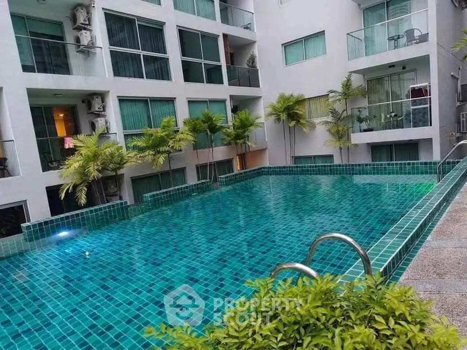 Luxurious apartment complex with stunning pool and modern balconies.