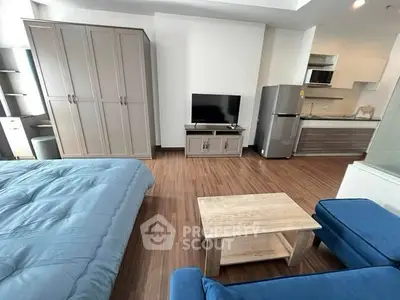 Modern studio apartment with open layout, featuring cozy living area, sleek kitchen, and stylish furnishings.
