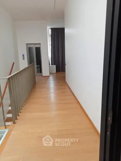 Spacious hallway with wooden flooring and modern design in a luxury property.