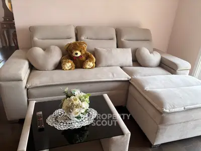 Cozy living room with plush sofa and elegant decor, perfect for relaxation and comfort.