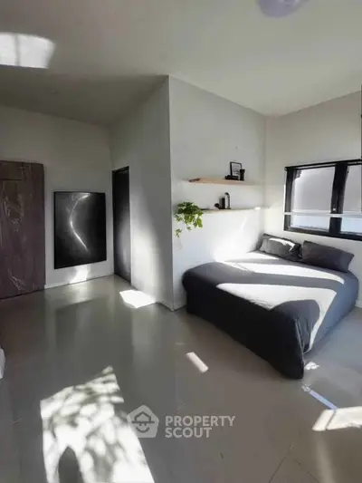 Modern minimalist bedroom with sleek design and natural light