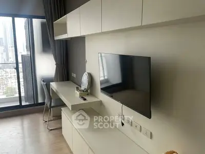 Modern living room with wall-mounted TV and city view from large window.