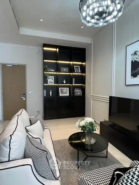 Elegant living room with modern decor, black shelving, and stylish lighting