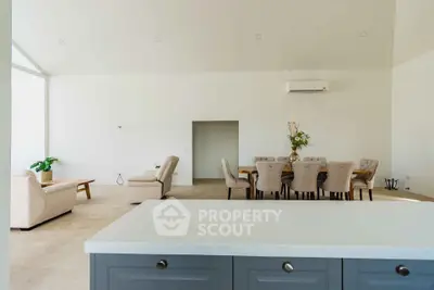 Spacious open-plan living and dining area with modern furniture and neutral tones.