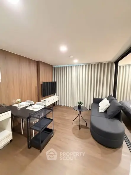 Modern living room with sleek furniture and wooden accents in a stylish apartment.