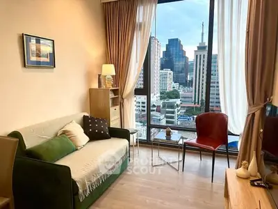 Modern living room with city view, stylish decor, and large windows in urban apartment.