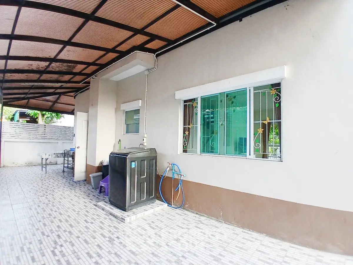 Spacious covered outdoor area with tiled flooring and modern design