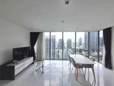 Spacious modern living room with panoramic city views and sleek furnishings