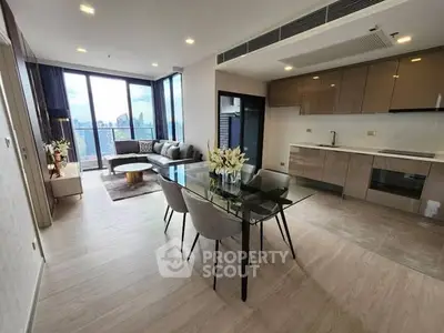 Modern open-plan living room with city view and sleek kitchen design