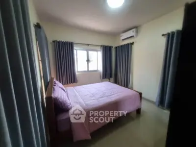 Cozy bedroom with natural light and air conditioning