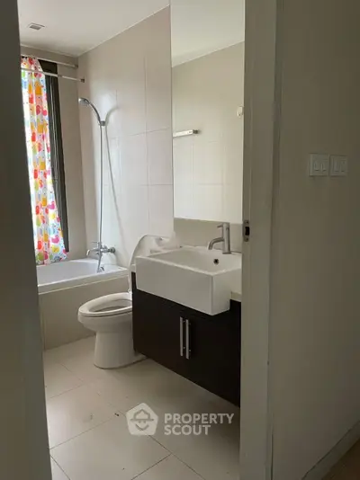 Modern bathroom with bathtub and stylish sink in a contemporary home.
