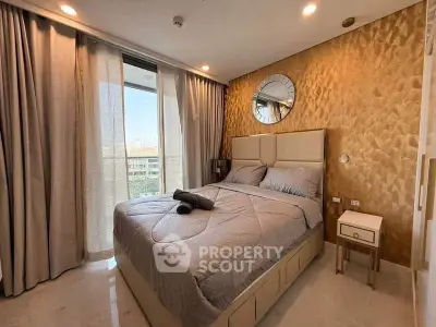 Luxurious bedroom with elegant decor and city view from large window.