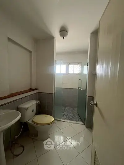 Cozy bathroom with shower and natural light, perfect for a refreshing start to your day.