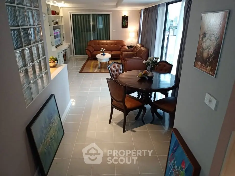 Spacious living room with elegant furniture and large windows offering natural light.