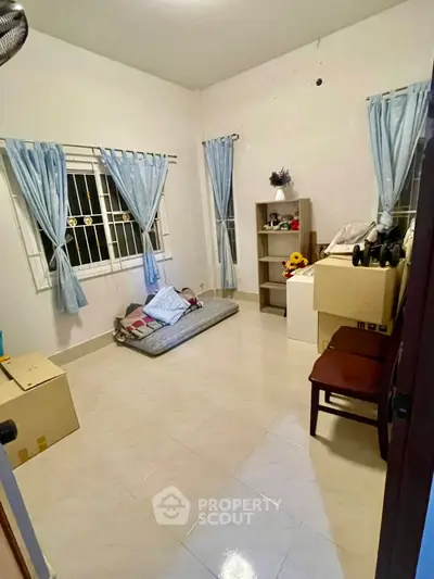 Cozy bedroom with simple decor and natural light, perfect for a peaceful retreat.