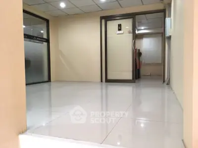 Modern office lobby with sleek glass doors and polished tile flooring