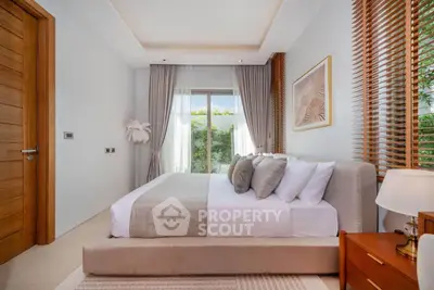 Luxurious bedroom with elegant decor and garden view, featuring plush bedding and stylish furnishings.