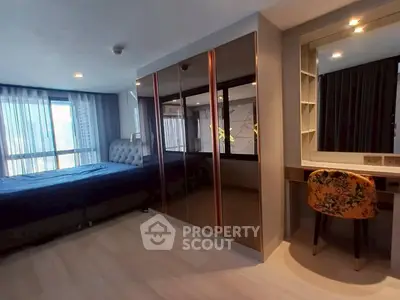 Spacious bedroom with modern decor and large window view