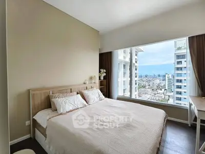 Spacious bedroom with stunning city view in modern high-rise apartment