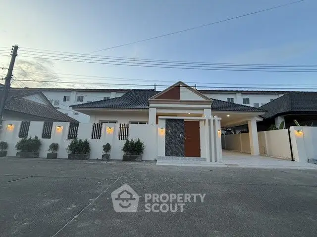 Charming single-story home with modern facade and spacious driveway