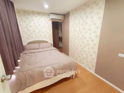 Cozy bedroom with floral wallpaper and air conditioning in modern apartment.