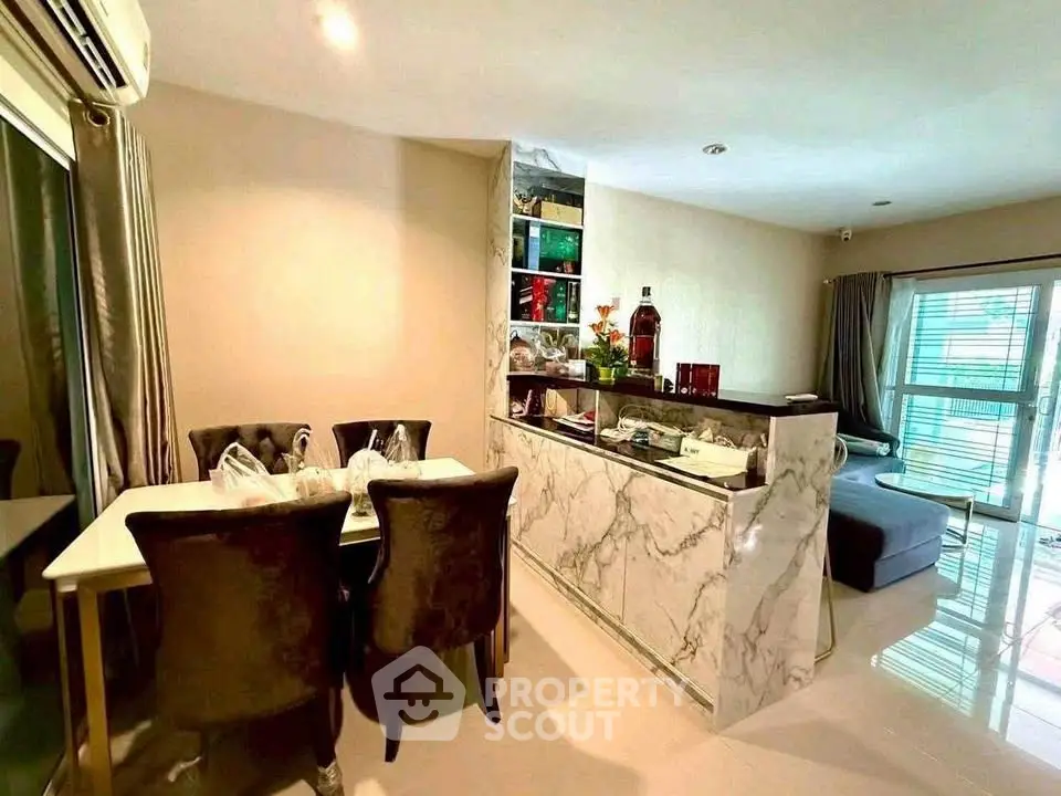 Modern living room with elegant dining area and marble accents