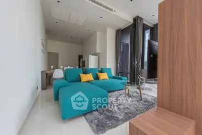 Spacious modern living room with turquoise sofa and stylish decor