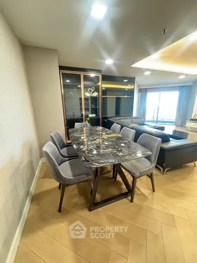 Luxurious dining area with marble table and plush chairs in modern living room