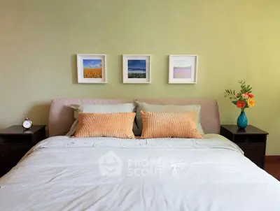 Cozy bedroom with stylish decor and vibrant flower arrangement