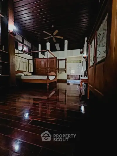 Luxurious wooden bedroom with polished floors and elegant furnishings.