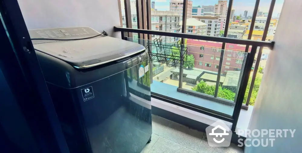 Modern balcony with city view and washing machine, perfect for urban living.