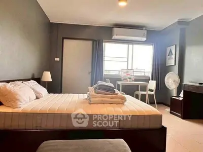 Spacious bedroom with modern decor and natural light