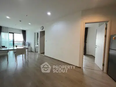 Spacious modern living room with open layout and balcony access, perfect for urban living.