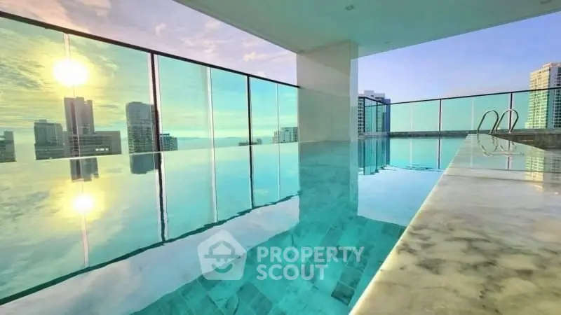 Luxurious rooftop infinity pool with stunning city skyline view at sunset.