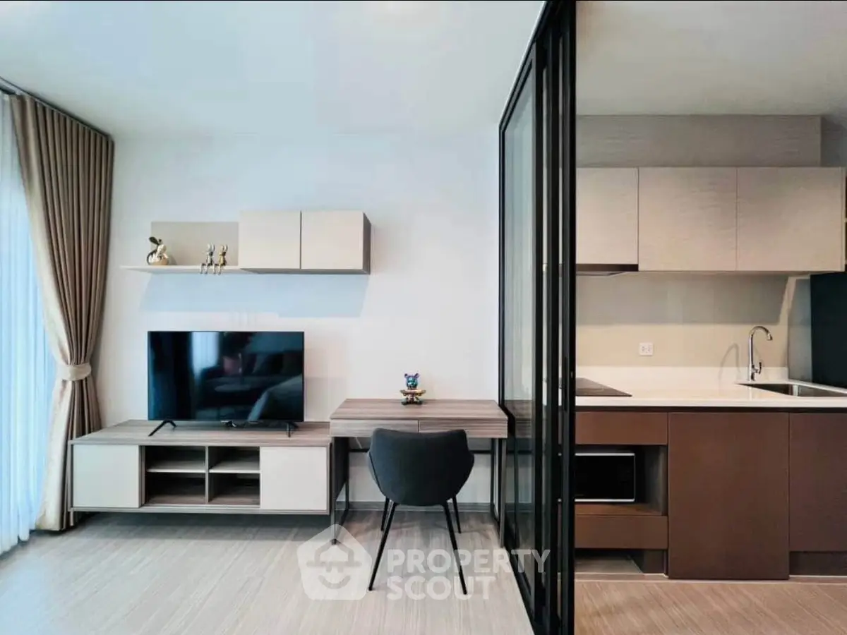 Modern open-layout living room with sleek kitchen and stylish decor