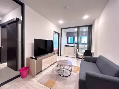 Modern living room with sleek furniture and open layout in a stylish apartment.