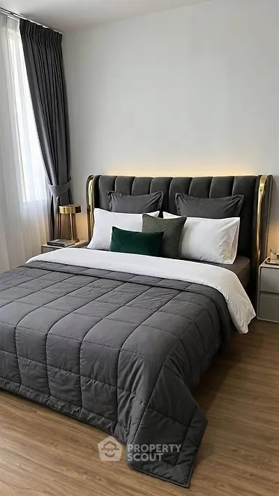 Luxurious bedroom with elegant decor and plush bedding in modern apartment.