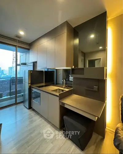 Modern kitchen with sleek cabinetry and city view balcony