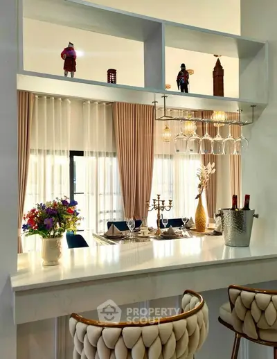 Luxurious kitchen with elegant bar seating and stylish decor