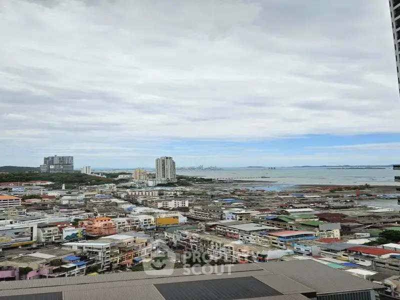 Stunning cityscape view from high-rise building overlooking ocean and skyline.