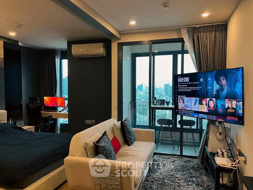 Modern studio apartment with city view, cozy living area, and sleek interior design.