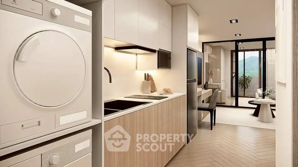 Modern kitchen with sleek appliances and open layout leading to stylish living area.