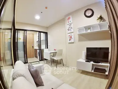 Modern living room with stylish decor and open layout, featuring a cozy sofa and wall-mounted TV.