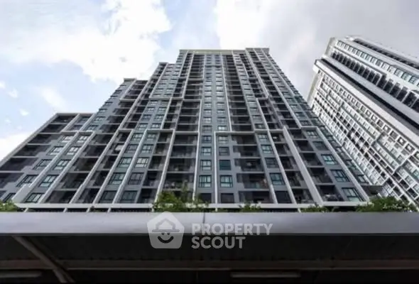 Modern high-rise residential building with sleek architecture and expansive windows.