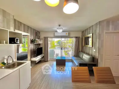 Spacious modern living room with open kitchen and balcony view