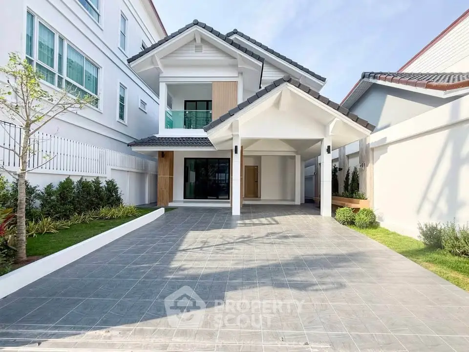 Stunning modern two-story house with spacious driveway and landscaped garden.