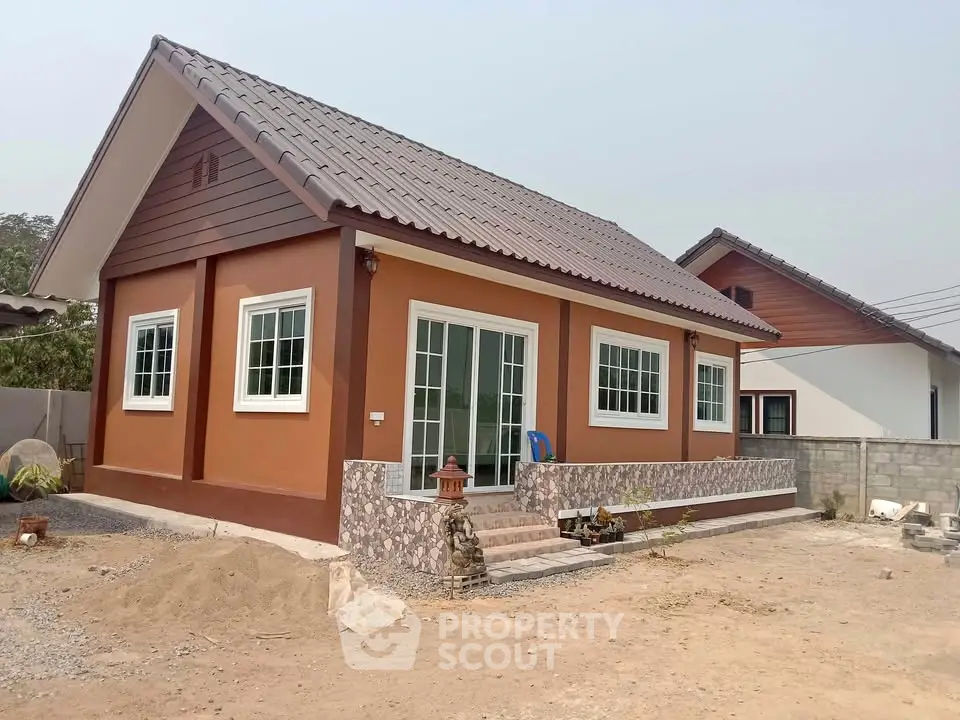 Charming single-story house with modern design and spacious yard.