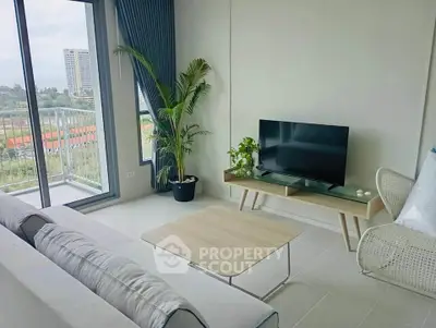 Modern living room with balcony view, stylish furniture, and natural light.