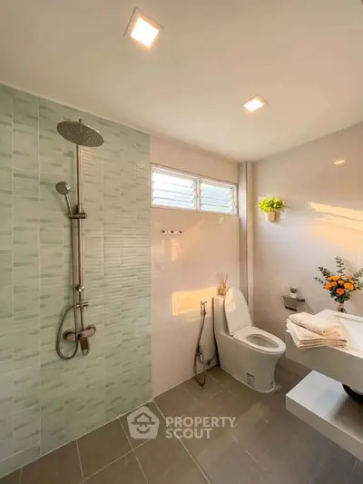 Modern bathroom with sleek shower and elegant fixtures in a bright, airy space.