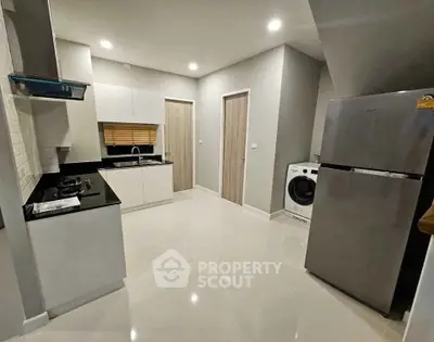 Modern kitchen with sleek appliances and ample storage space